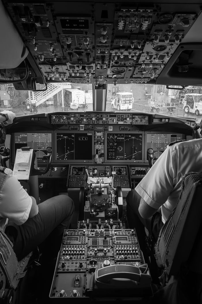 The Art of Drawing Readers In: Your attractive post title goes here Detailed view of an airplane cockpit with two pilots in black and white.